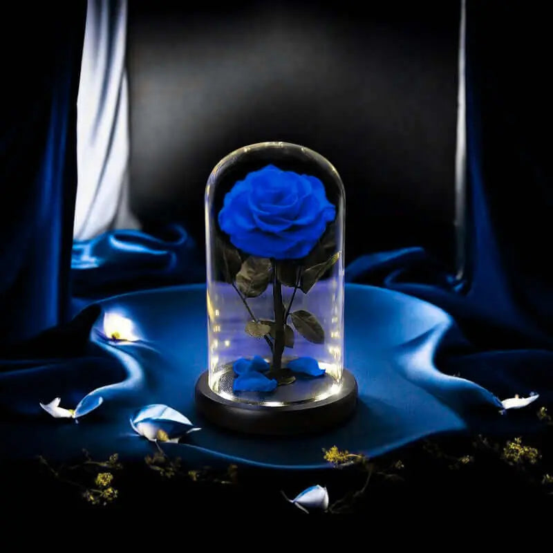 Elegant blue rose in a glass dome with LED lights, perfect for home decor or gifts.